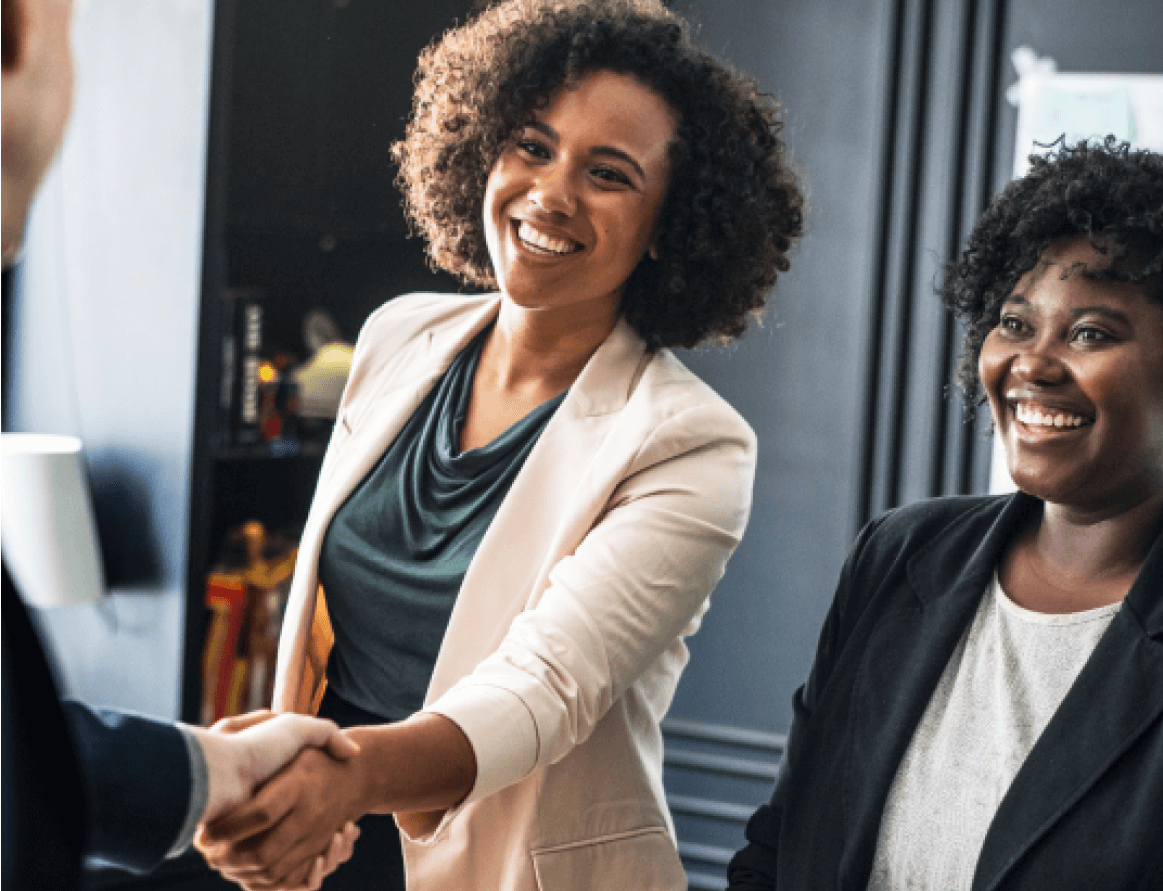 A smiling woman shaking a hand