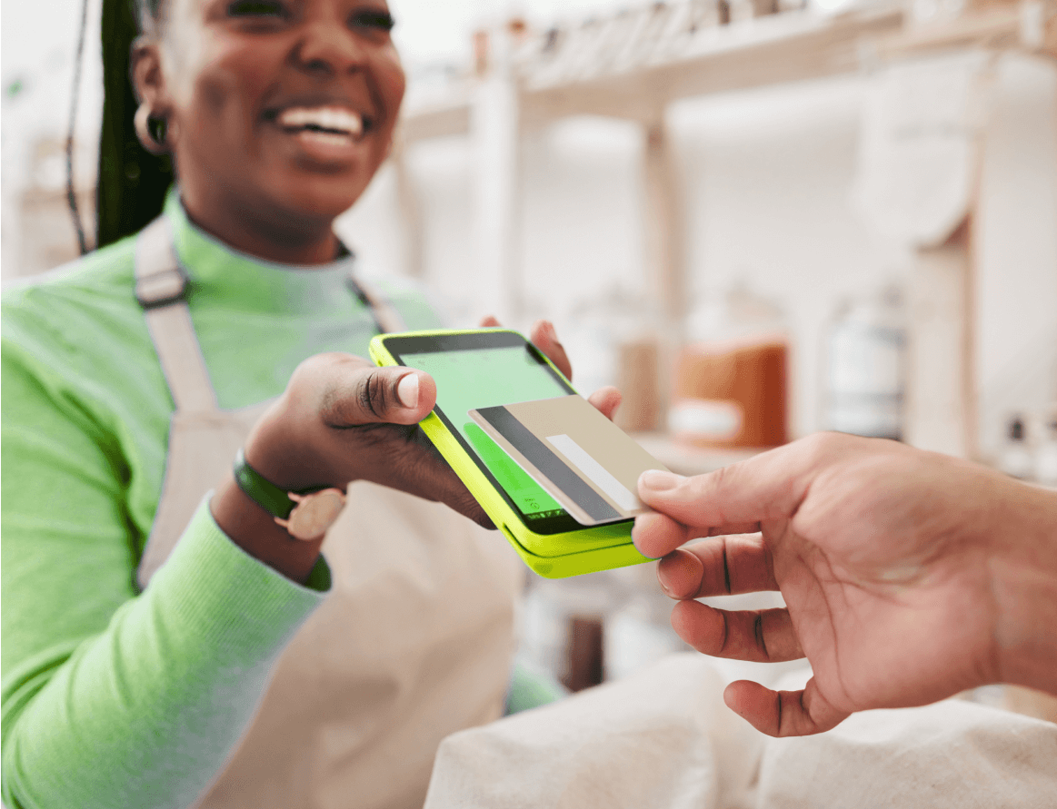 A smiling woman holding a POS device
